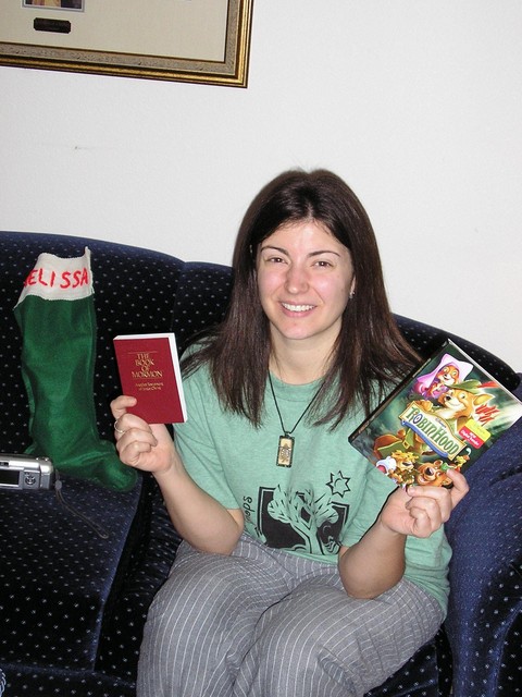 Missi with the tiny Book of Mormon that Amy gave us all (for our 72 hour kits), and the Robin Hood DVD from Dave.
