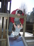 Kyton isn't too sure about the slide, but grandpa helps