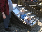 Both boys on the toddler slide