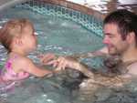 Dad and daughter in the pool.