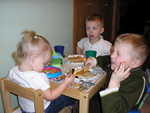 Rhya, Kyton, & Toric having cheese and crackers at their little table.