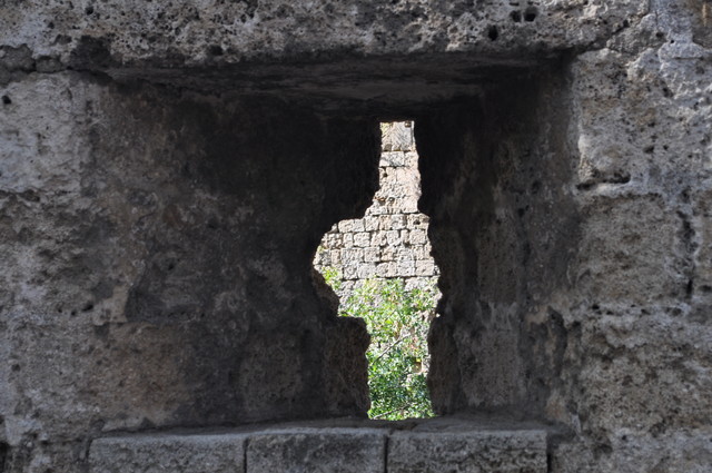 Arrowslit or balistraria or better known as a loophole.  Rhodes