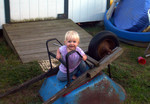 Dory climbed onto the wheelbarrel by herself, and shouted to let me know how proud she was of herself.