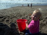 Rhya, either eating the sand, or filling a bucket. Depended on the moment.